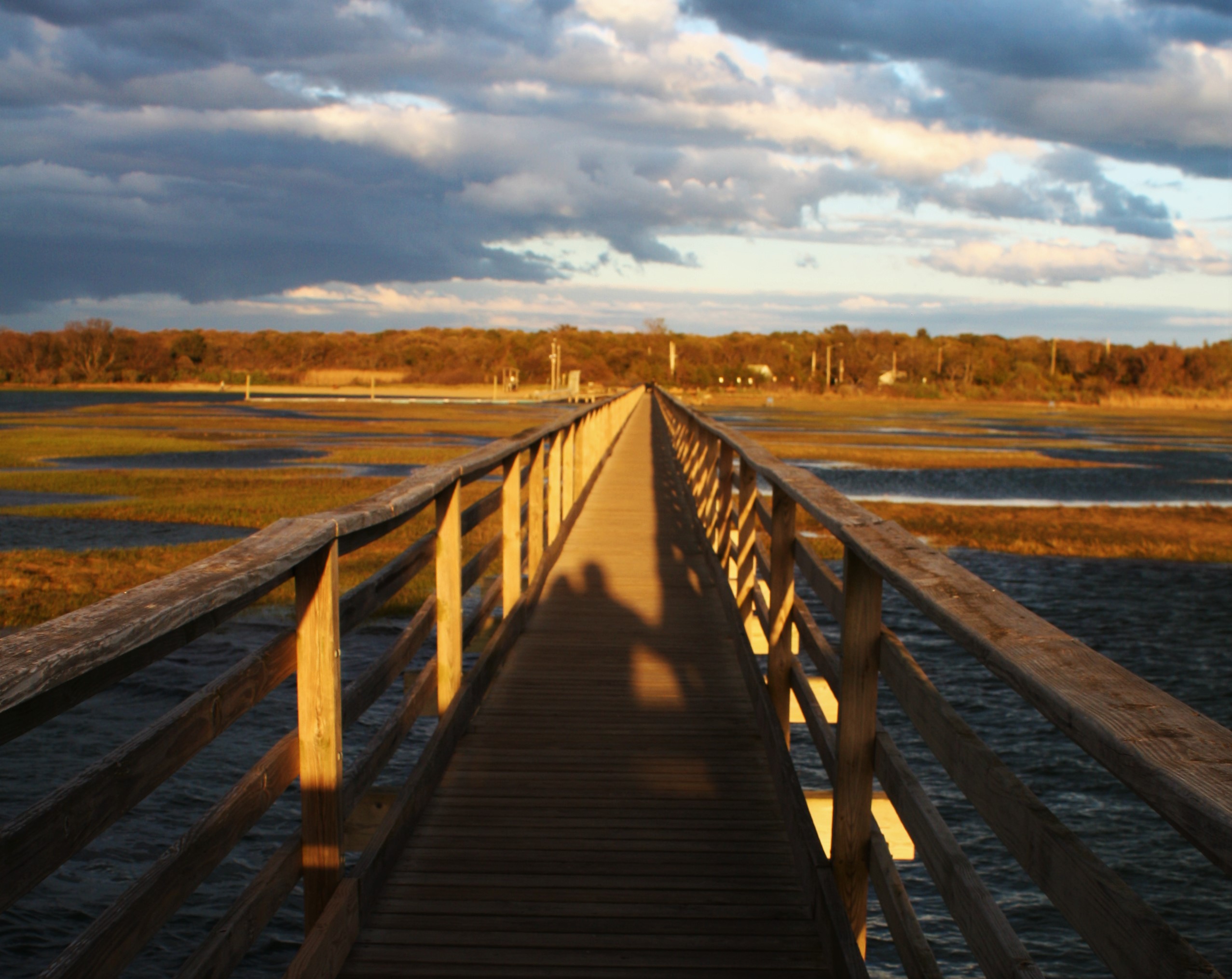 Sunset casting shadows on pier in Cape Cod....