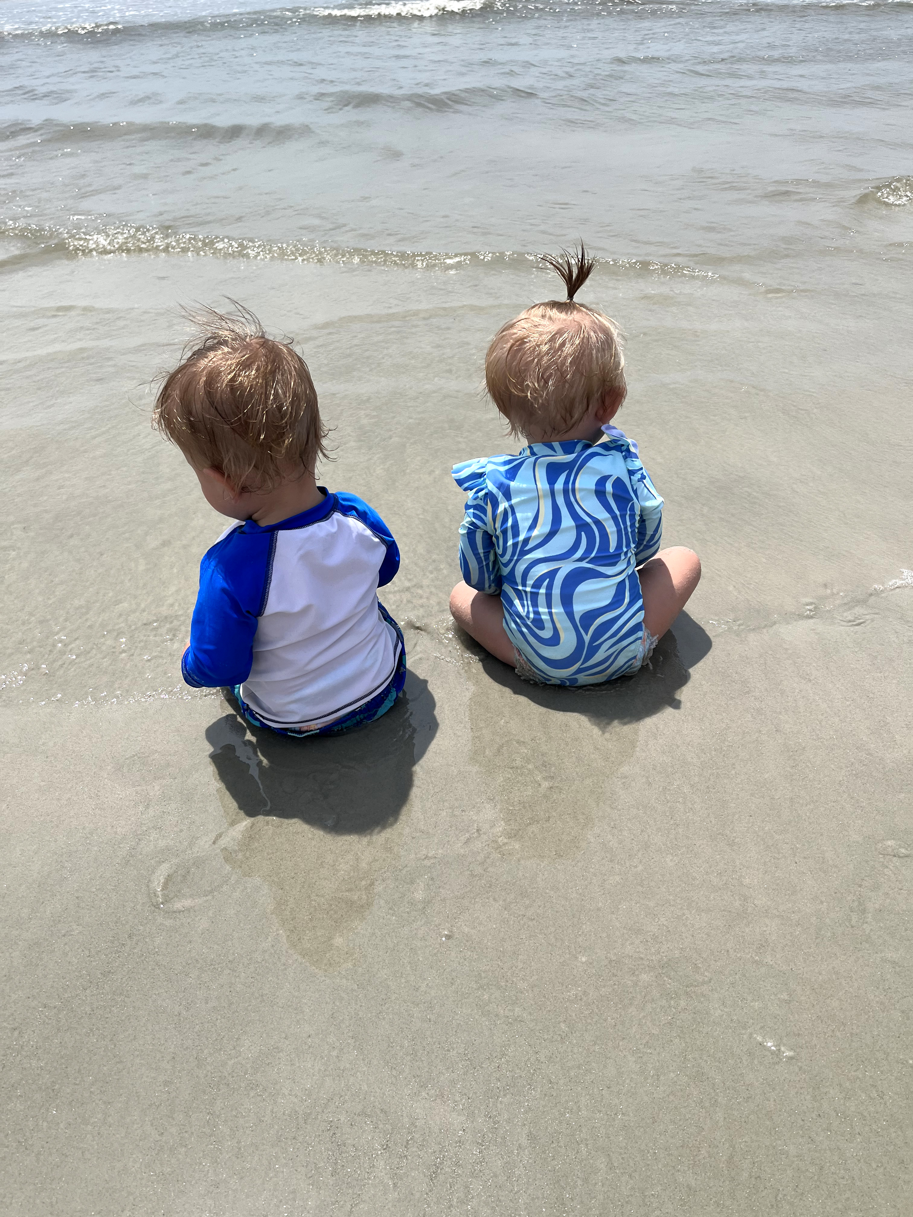 One year old boy/girl twins experiencing the beach...
